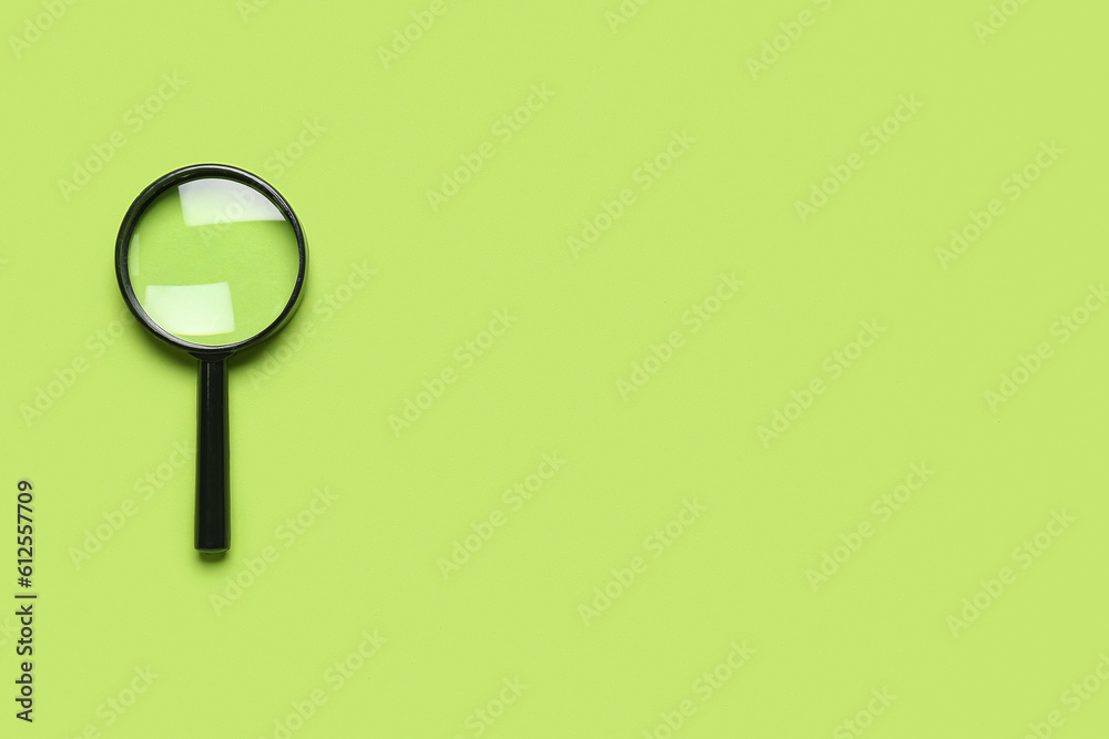 Black mini magnifier on green background