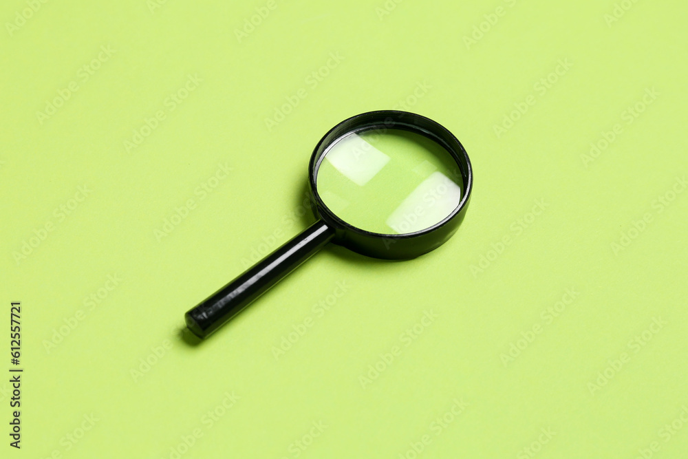 Black mini magnifier on green background