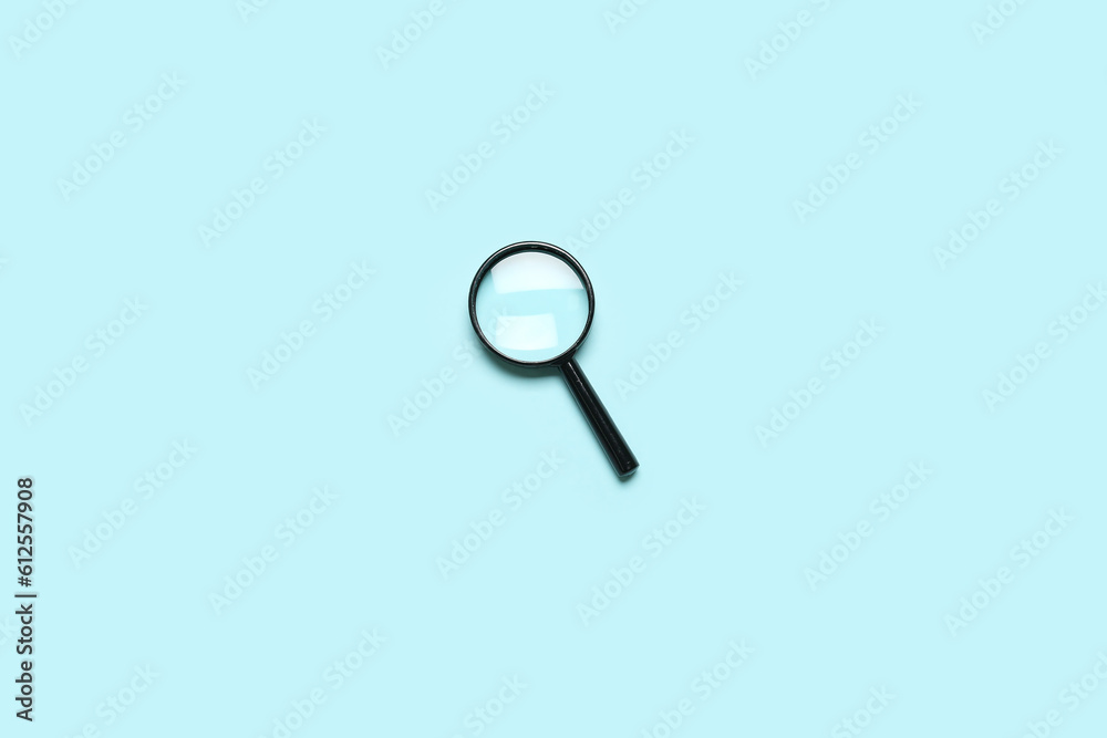 Black mini magnifier on blue background