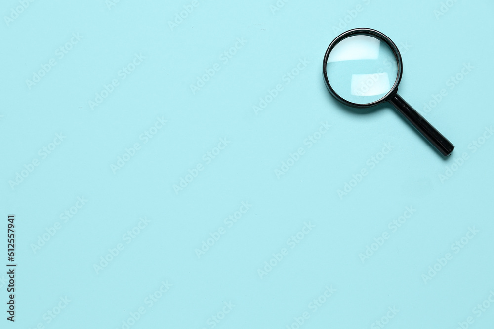 Black mini magnifier on blue background