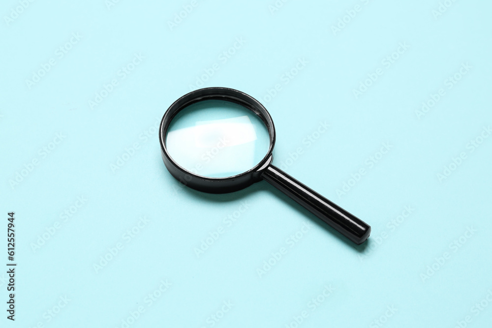 Black mini magnifier on blue background