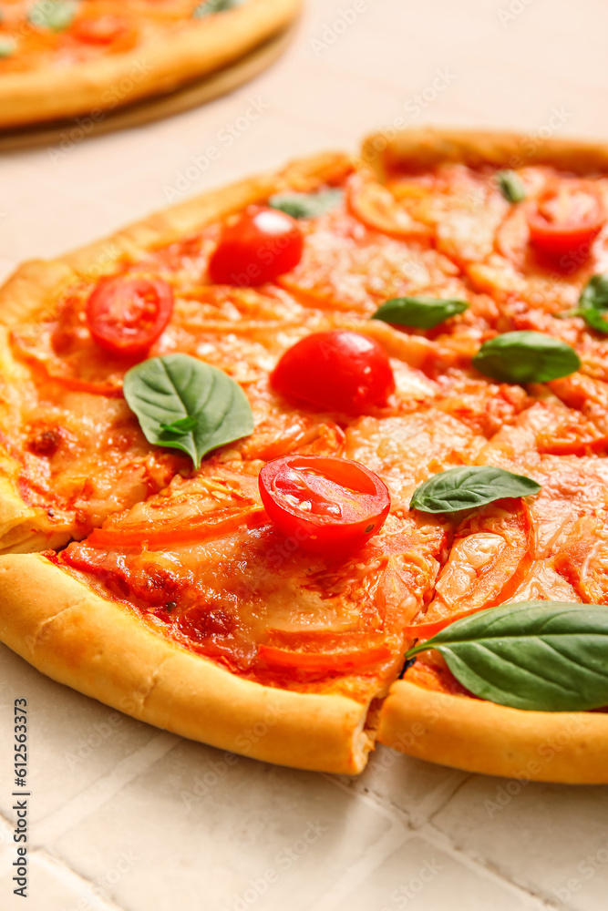 Tasty pizza margarita on beige tile background