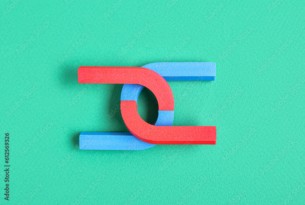 Horseshoe shaped magnets on green background