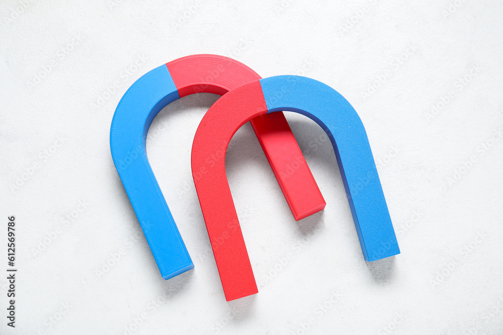 Horseshoe shaped magnets on white background