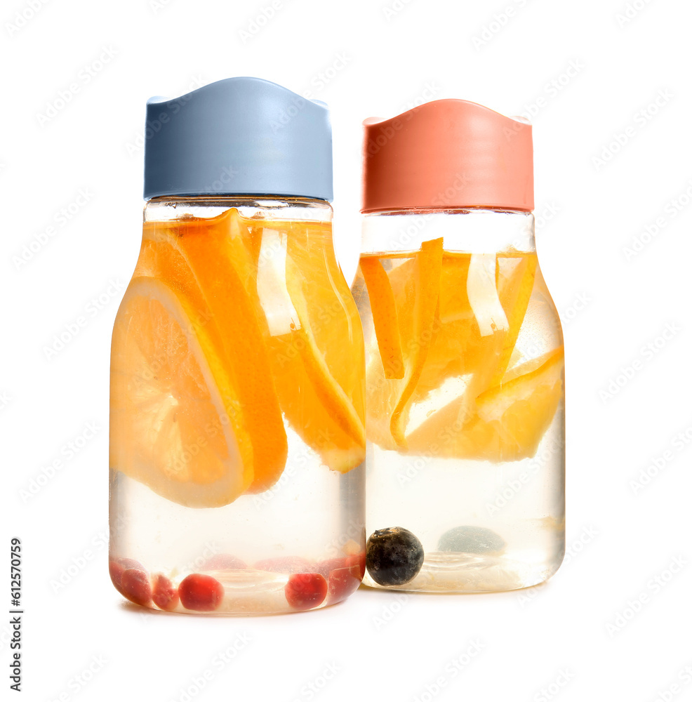 Sports bottles of infused water with orange slices on white background