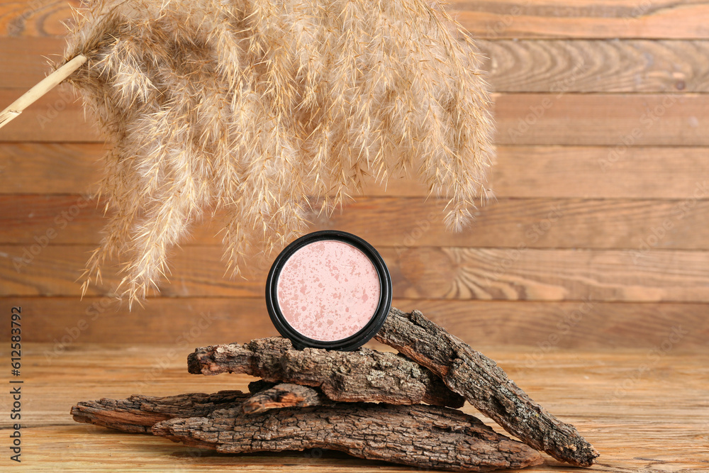 Composition with highlighter, tree bark and pampas grass on wooden background