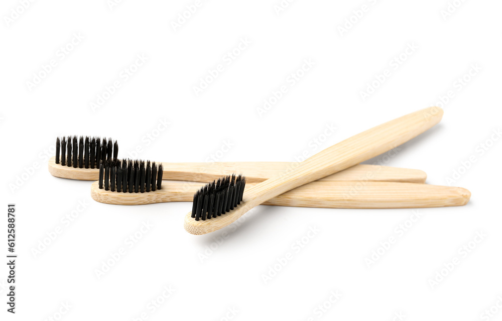 Bamboo toothbrushes on white background