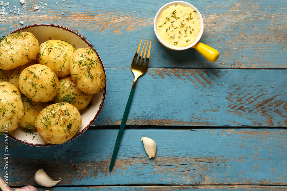 Plate of boiled baby potatoes with dill on blue wooden background