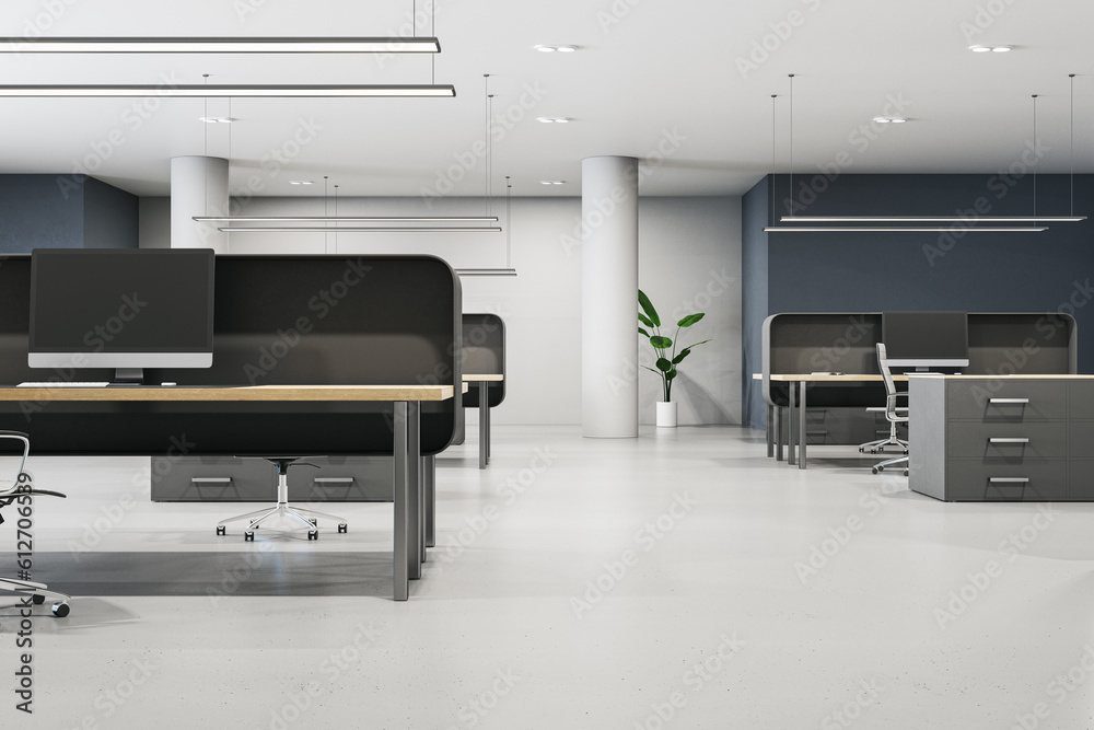 Contemporary coworking office interior with furniture, empty computer monitors and concrete flooring