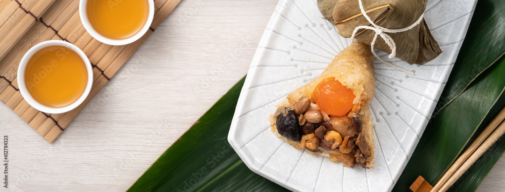 Zongzi. Rice dumpling for Dragon Boat Festival on bright wooden table background with ingredient.