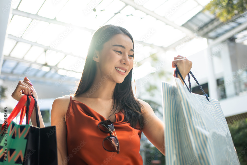 Asian beautiful woman shopping goods outdoor alone in department store. 