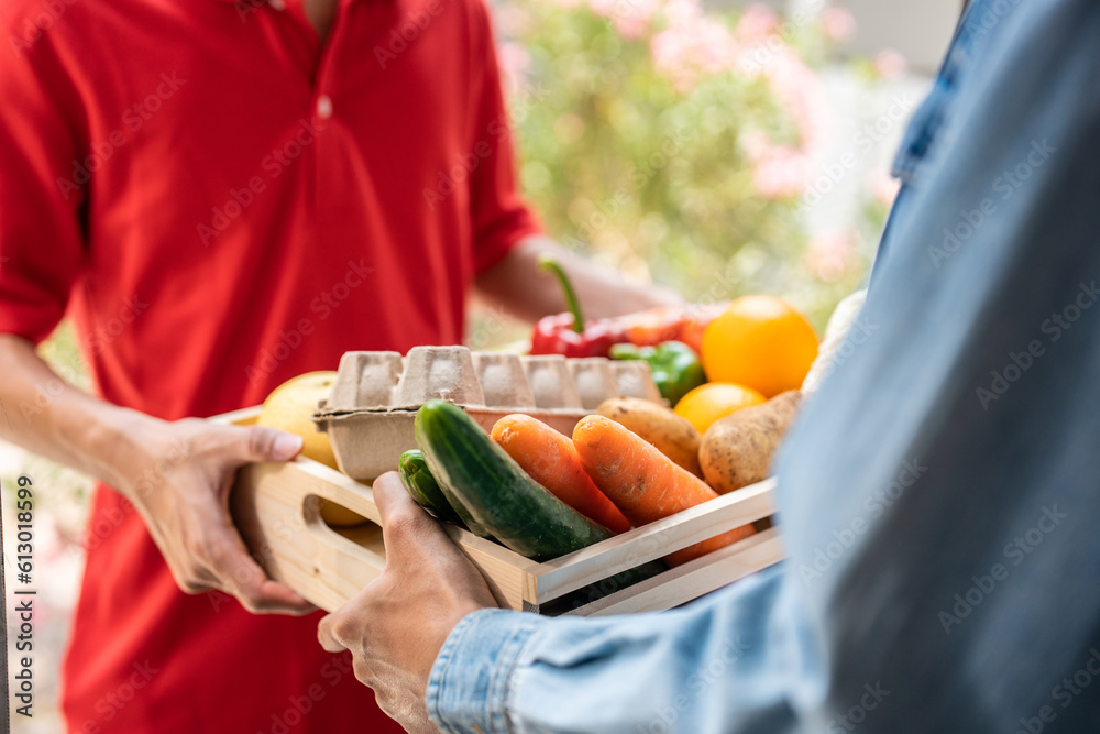 Close up hands of young delivery man delivering package to customer. 