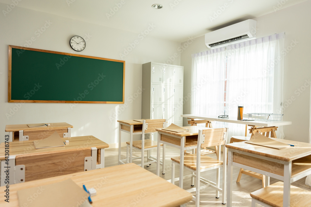 Shot of empty classroom with chairs under desks in elementary school. 