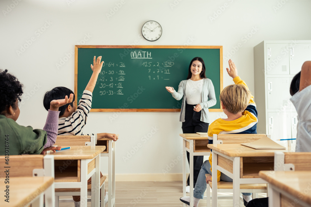 Group of student learn with teacher in classroom at elementary school. 