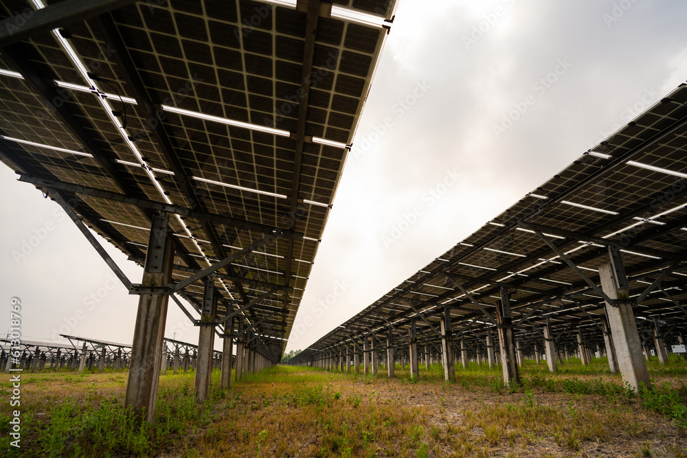 Shot of ecology solar power station panels in a field during sunset. 