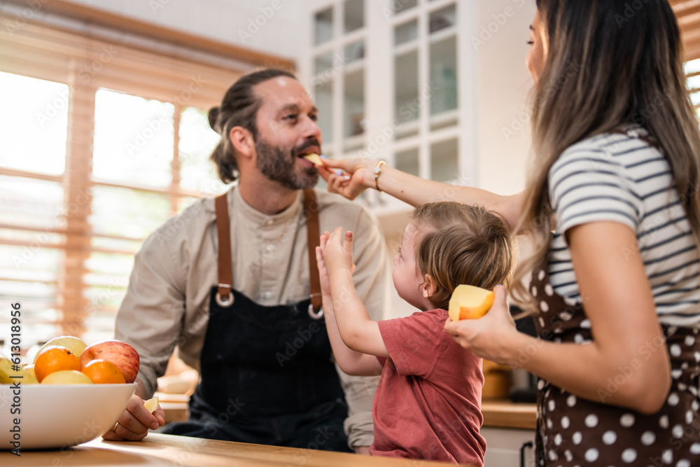 Caucasian attractive couple baking bakery with son in kitchen at home. 