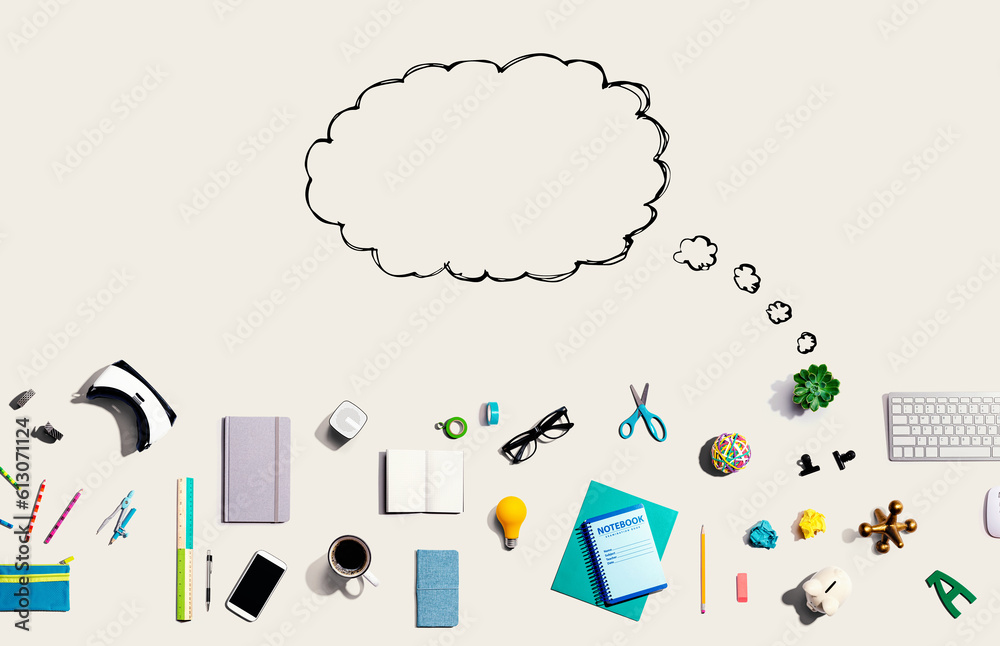 Blank speech bubble with collection of electronic gadgets and office supplies