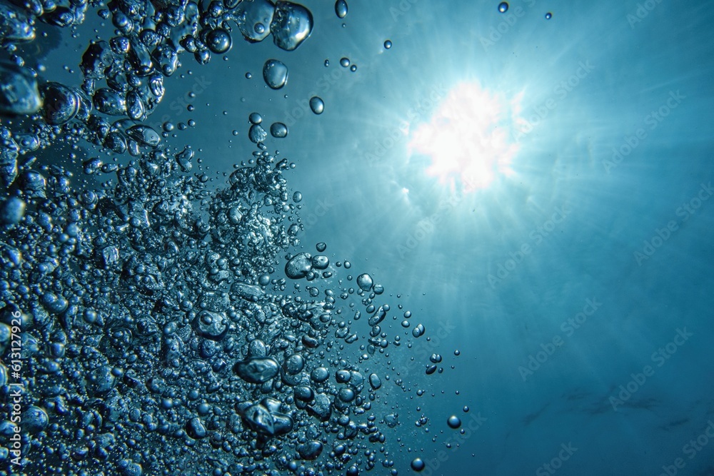 Bubbles and sunlight underwater. Blue abstract background.