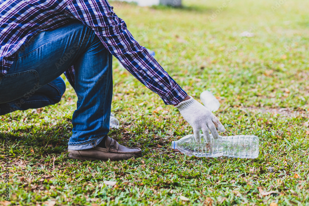 Volunteers picking up plastic bottles on the parks lawn.