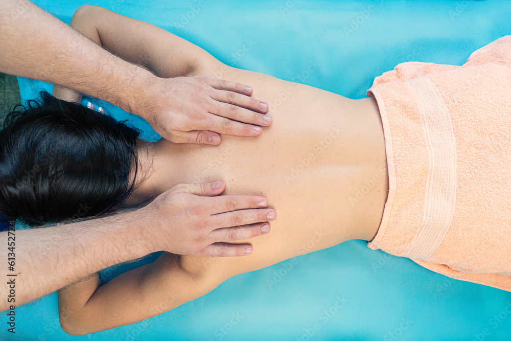 Top view. Spa therapy on a blue background. Beautiful asian woman having massage in beauty salon.