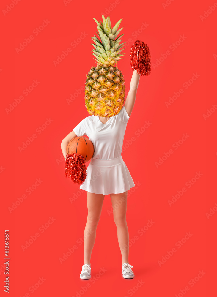 Beautiful young cheerleader with ball on color background