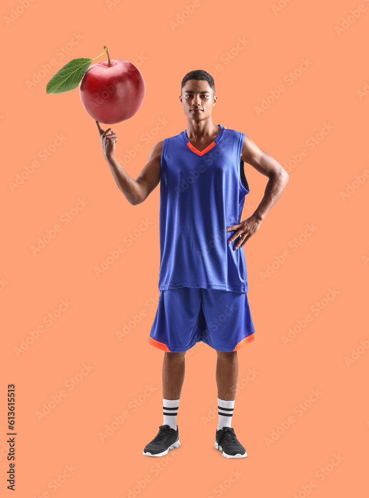 Young African-American basketball player on white background