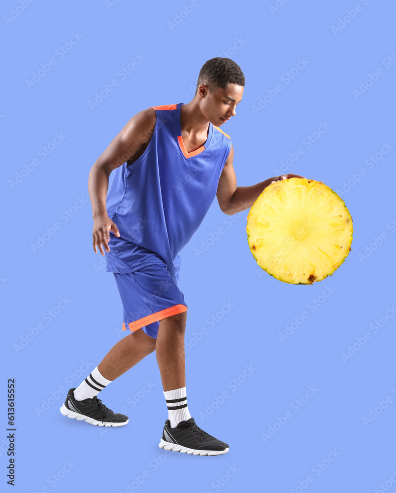 Young African-American basketball player on white background