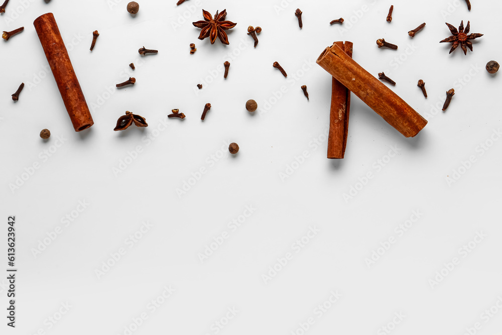 Composition with aromatic clove, cinnamon, allspice and anise stars on light background