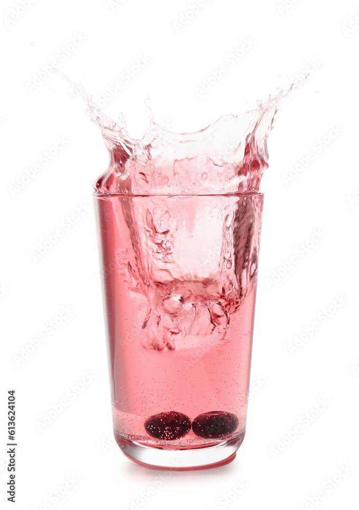 Glass of tasty blueberry cider with splashes, ice cube and berries isolated on white background