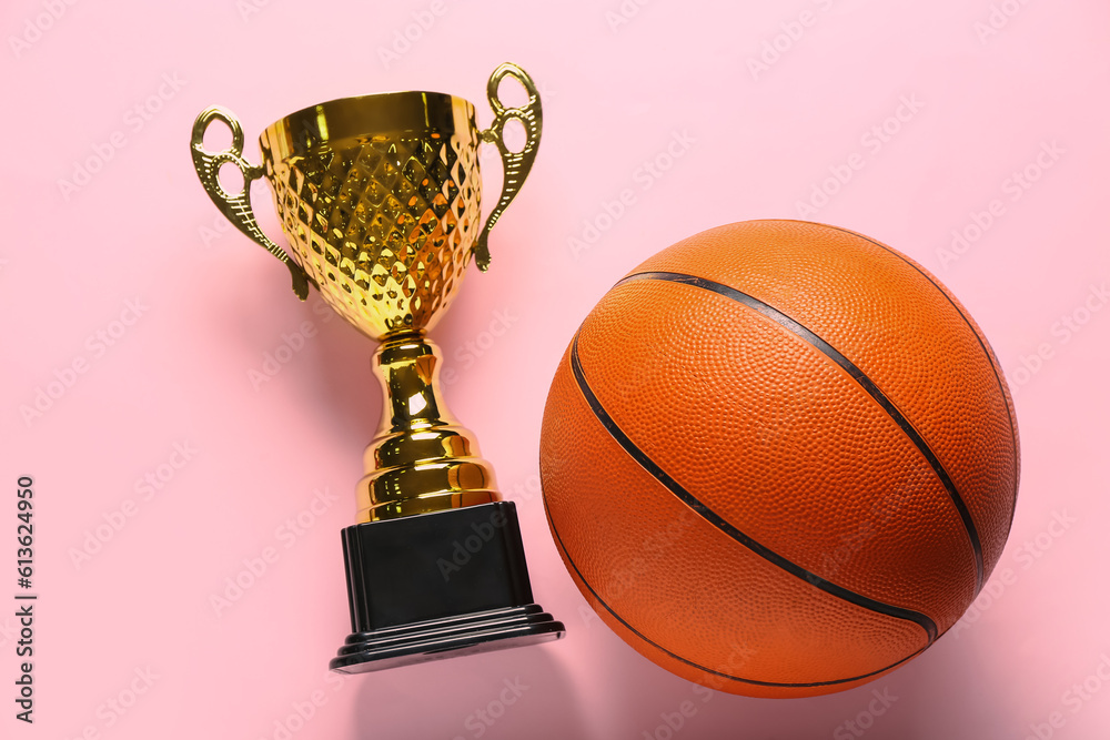 Gold cup with ball on pink background