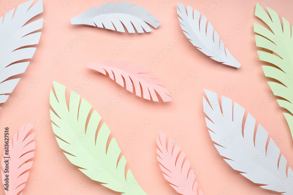 Paper tropical leaves on pink background