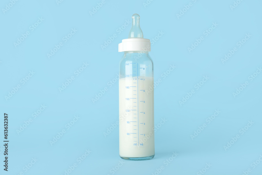 Bottle of milk for baby on blue background