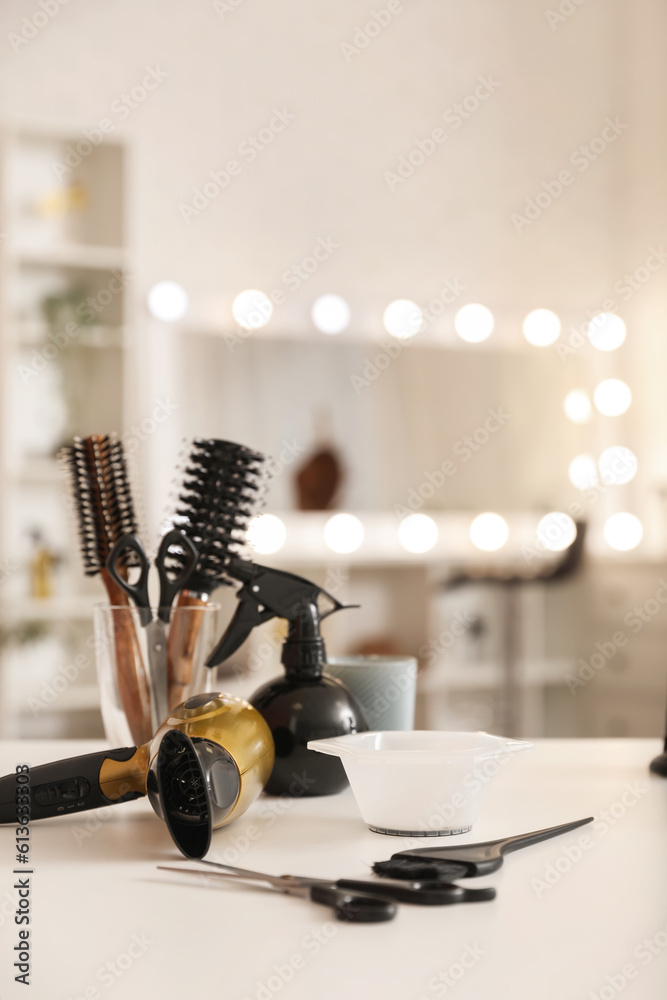 Different hairdressing tools on table in beauty salon