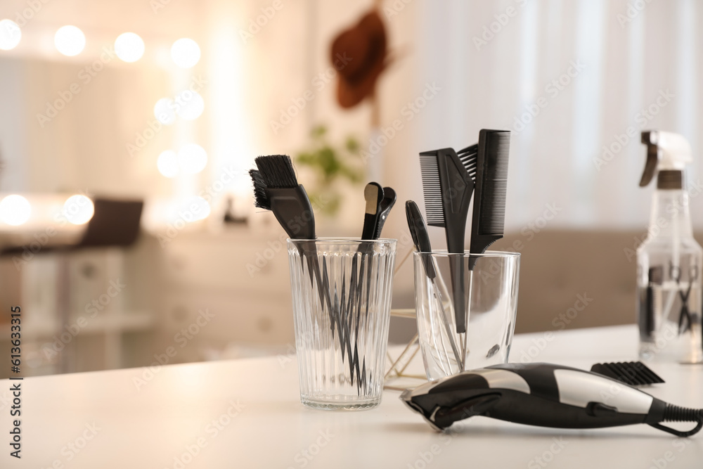 Different hairdressing tools on table in beauty salon