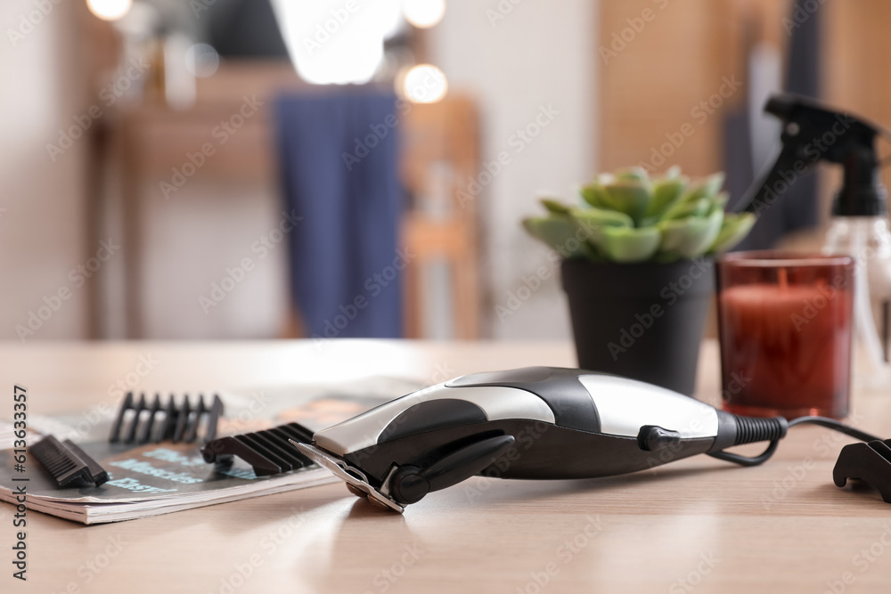 Modern trimmer on table in beauty salon