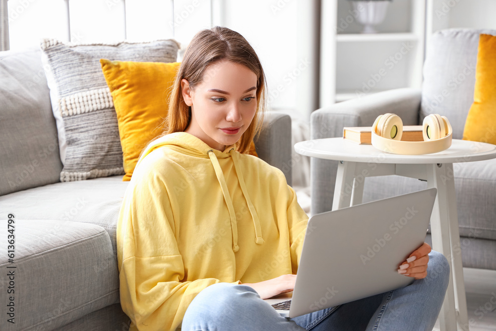 Female student studying with laptop at home