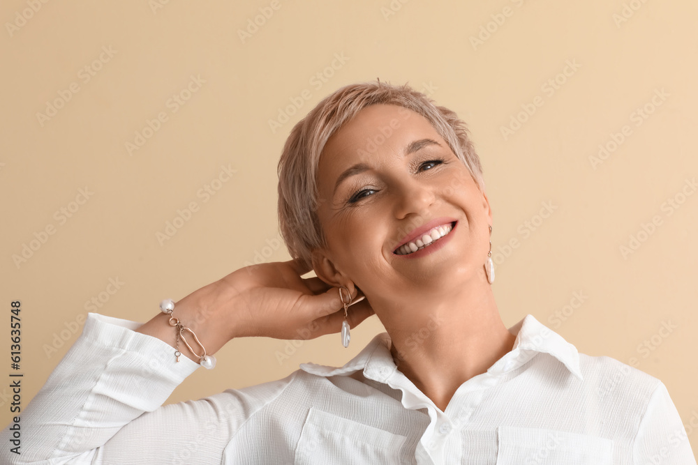 Mature blonde woman on beige background, closeup