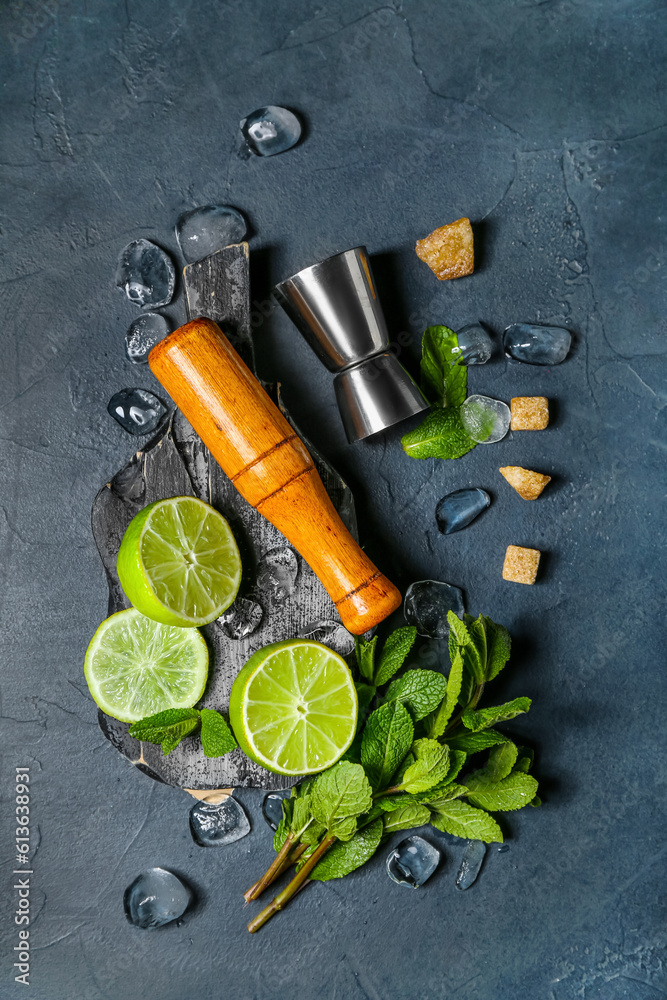 Mortar, measure cup and ingredients for preparing mojito on dark background