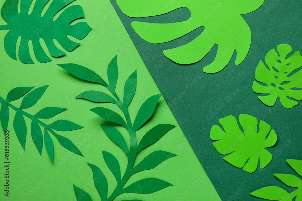 Beautiful origami leaves on green background