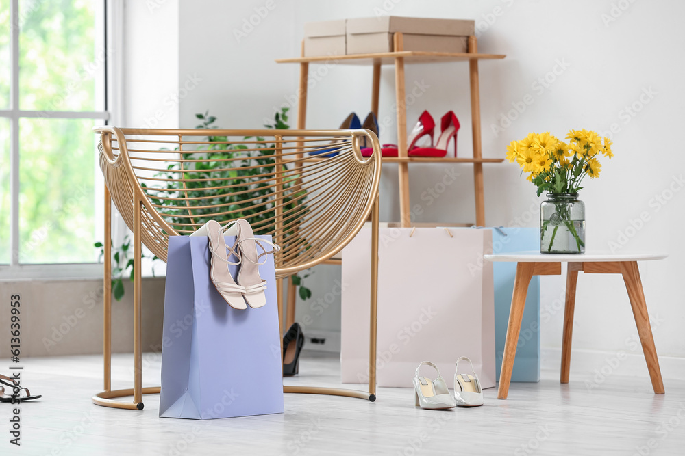 Interior of shoe store with armchair and shelving unit