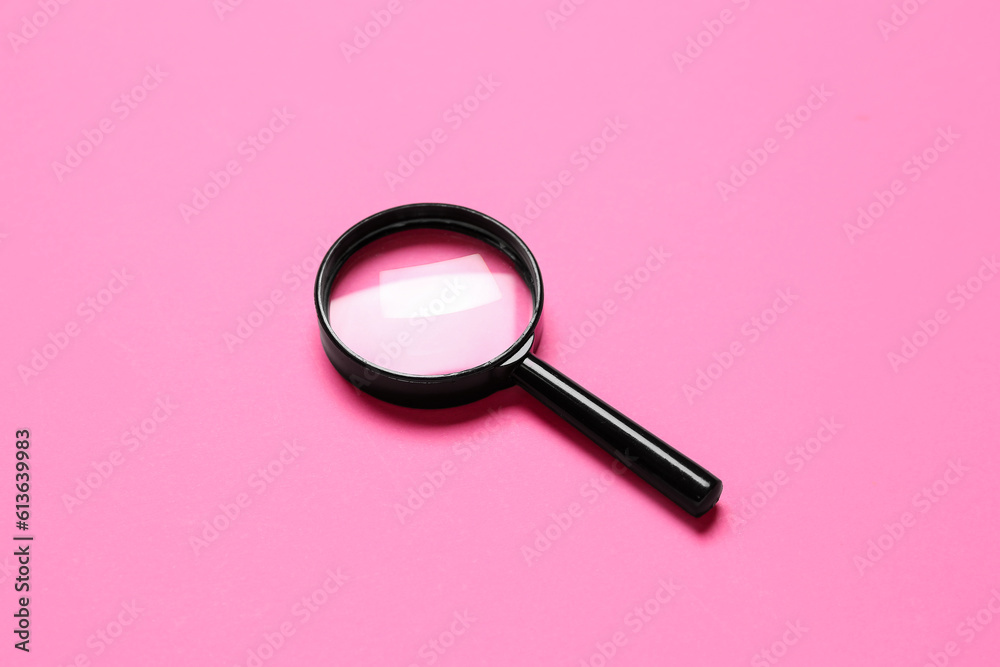 Black mini magnifier on pink background