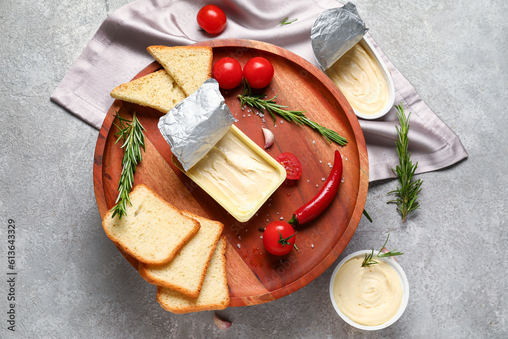 Plastic containers with tasty cream cheese, bread and vegetables on grey background