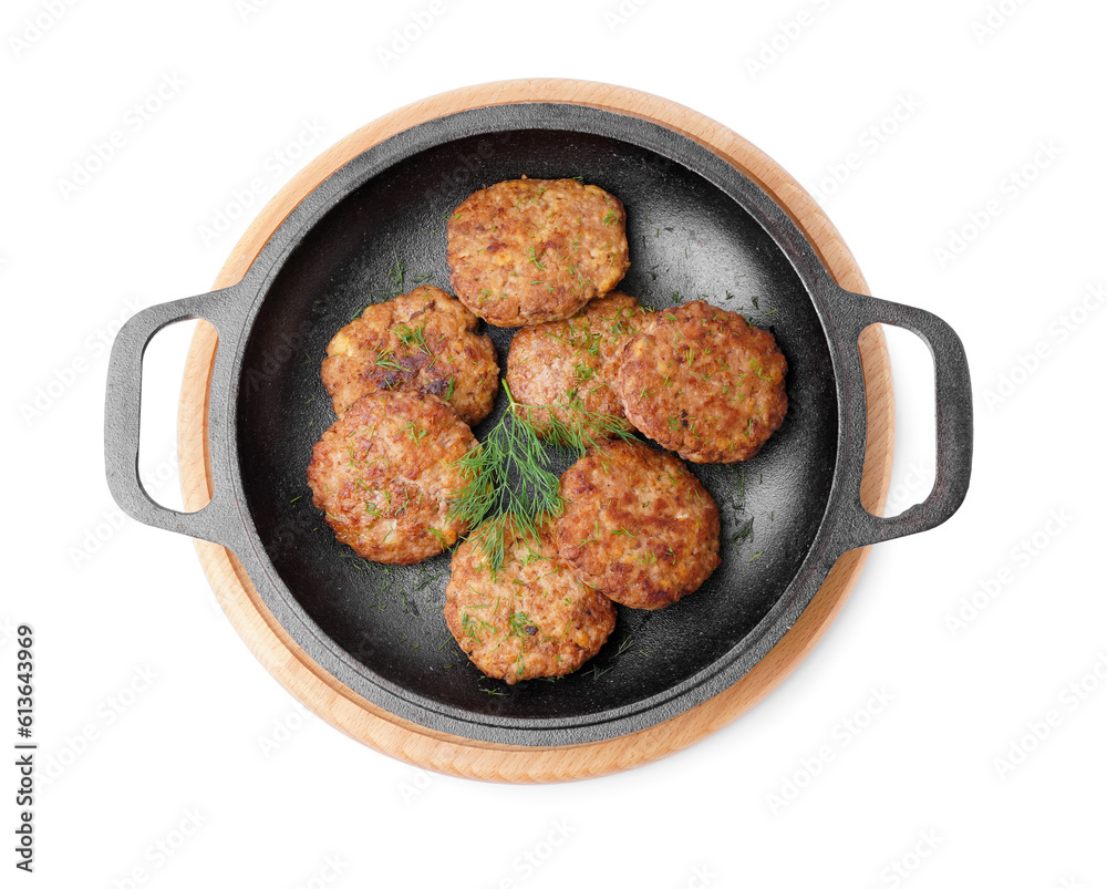 Frying pan with cutlets, dill and wooden board on white background