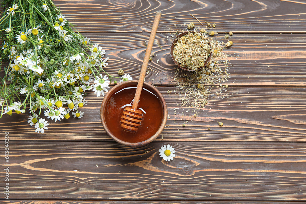 Composition with bowl of honey, fresh and dried chamomile flowers on wooden background