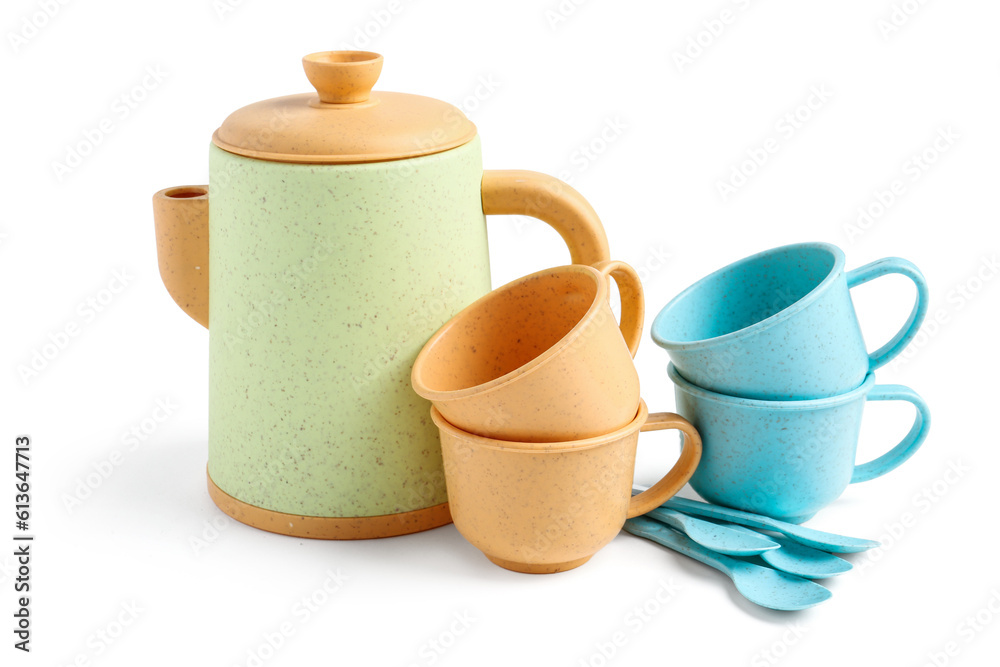 Teapot with cups and spoons isolated on white background. Childrens Day celebration