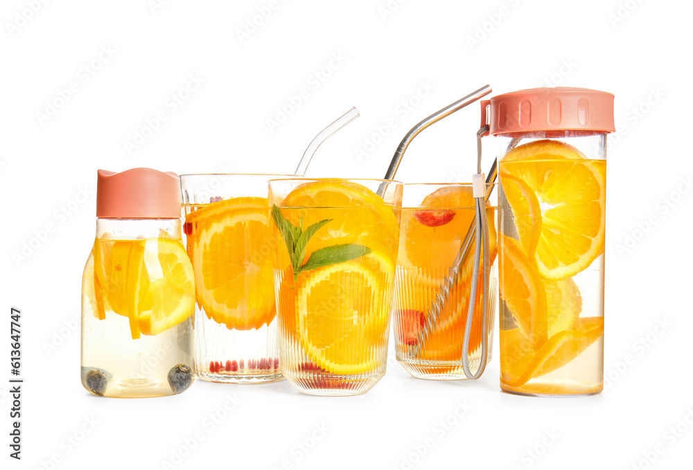 Glasses and sports bottles of infused water with orange slices on white background