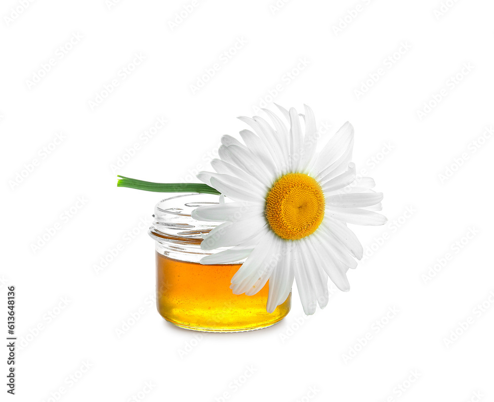 Jar of honey and beautiful chamomile flower on white background