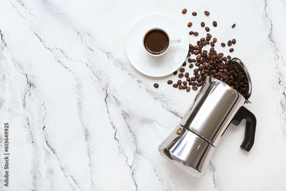 Cup of hot espresso and geyser coffee maker on white marble background