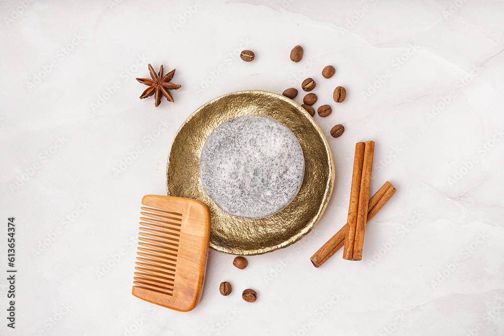 Handmade solid shampoo, hair comb and spices on light background