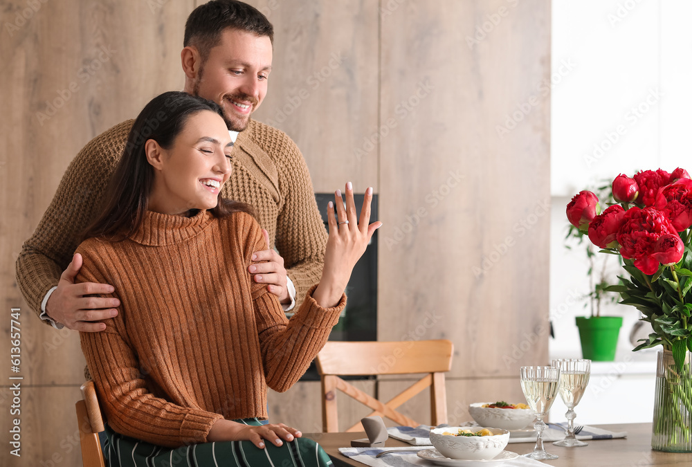 Happy engaged couple in kitchen